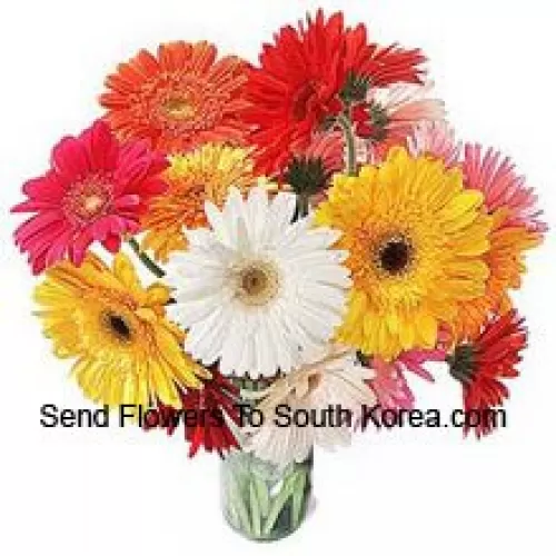 18 Mixed Colored Gerberas With Some Ferns In A Glass Vase