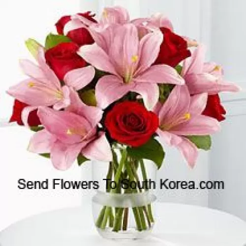 Red Roses And Pink Lilies With Seasonal Fillers In A Glass Vase